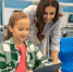 Woman looking into tablet of happy girl - Сетевое издание Арбуз